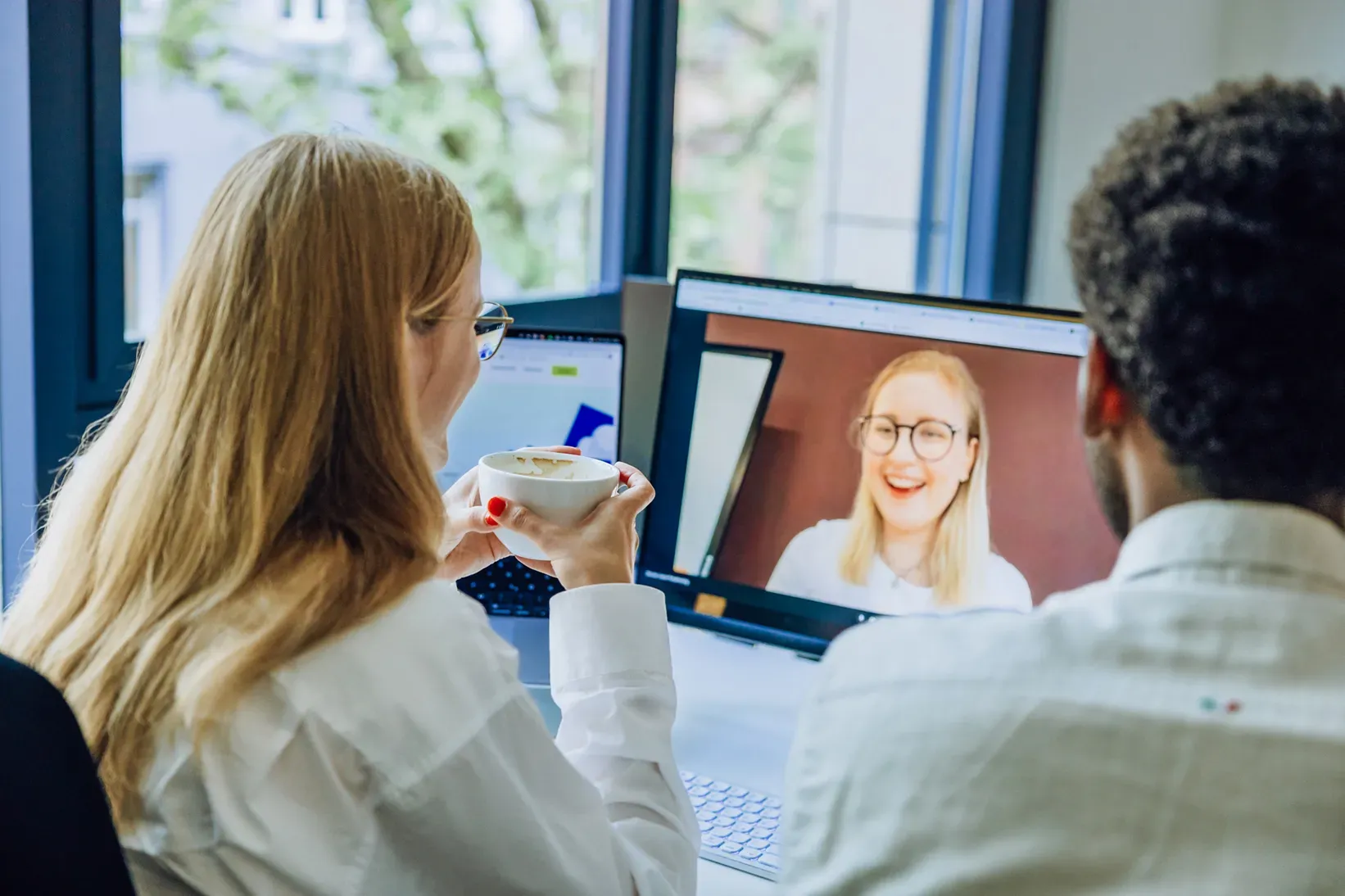 Digital meeting discussion over laptop with coffee